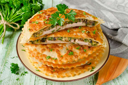 Meat with mushrooms, cheese and herbs baked in crispy doughの写真素材