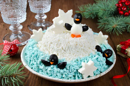 Festive salad penguins on an ice floe. The idea for a delicious and merry holidaysの写真素材