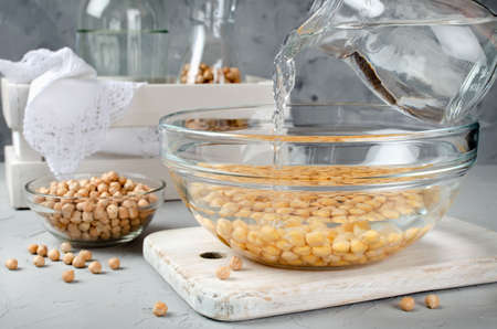 Chickpea soaked in water in a glass bowl. Ingredients for cookingの写真素材