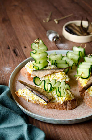 Bruschetta with sprats, egg and cucumber. Fresh foodの写真素材