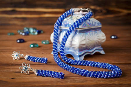 Necklace made of small beads set with handmade earrings. Blue bead decoration