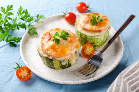 Zucchini stuffed with minced meat and rice, with tomatoes and mozzarella. Baked in the oven.の写真素材