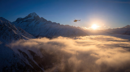 Aerial view of airplane flying above the clouds at sunset. Caucasus Mountains, Georgia, region Gudauri.の素材