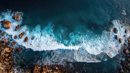 Aerial view of beautiful turquoise sea with waves and rocks.の素材