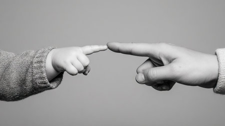 Black and white photo of father and son holding hands. Black and white image.の素材