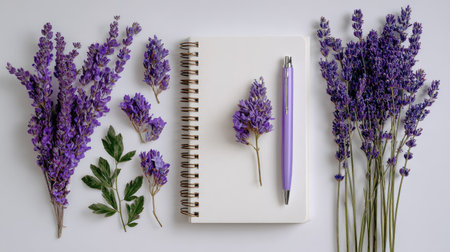 Flat lay composition with lavender flowers, notebook and pen on white backgroundの素材