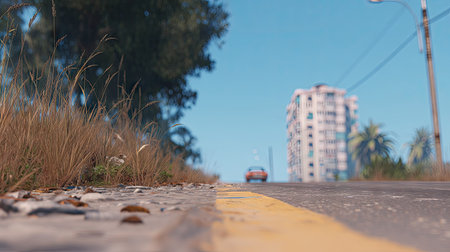 road on the street with blue sky and buildings in the background.の素材