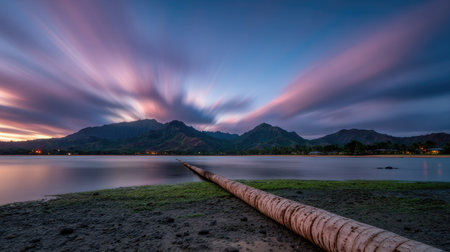 Long exposure of a long exposure of a stormy sky over a lake with a mountain in the backgroundの素材