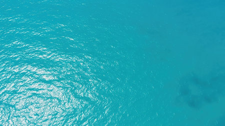 Aerial view of turquoise ocean water surface with ripplesの素材