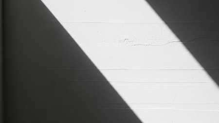 White concrete wall with shadow from the sun and shadows from the window.の素材