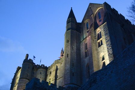 Mont Saint-michel abbey tower lit up at night twilight skyの写真素材