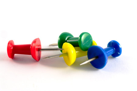 various coloured pins over white backgroundの写真素材