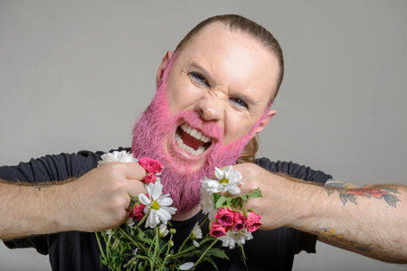 Man with long styled hair and pink beard with flowers on the white background