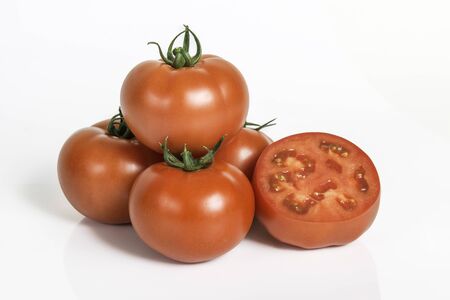 Group ripe red fresh tomatoes with sliced one isolated on white background. Studio shot of group vegetables.の写真素材