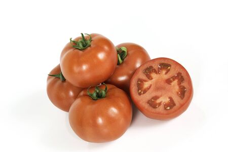Group of red fresh tomatoes with sliced one on a white backgroundの写真素材