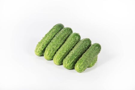 Group of fresh green pickling cucumbers isolated on white backgroundの写真素材