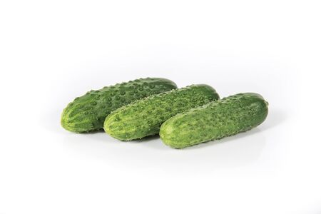 Group of fresh green pickling cucumbers isolated on white backgroundの写真素材