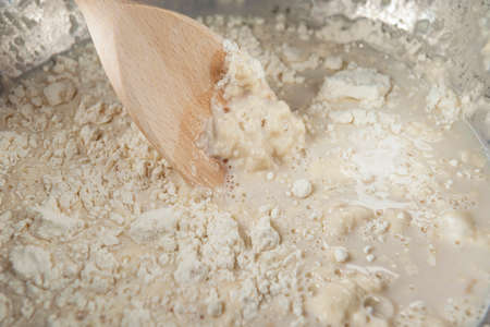 The process of mixing wheat flour, water and yeast with wooden spoon. Process of making yeast dough. The Adjarian Khachapuri Recipe â Georgian cheese bread.の写真素材
