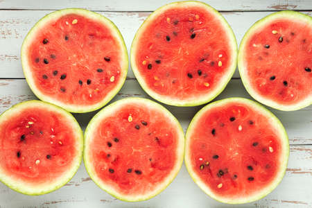Round slices of watermelon on the white wooden Provence style table.の写真素材