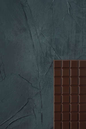 Chocolate bar on the grey textured background. Top view. Flat lay. Copy space. Space for text.の写真素材