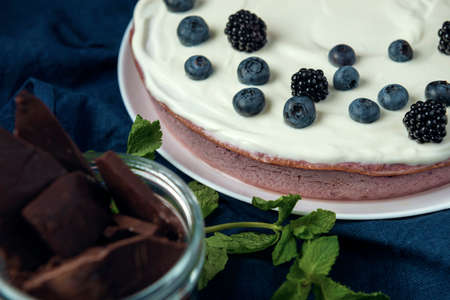 Cottage cheese casserole and glass jar with chocolate pieces on the blue napkinの写真素材