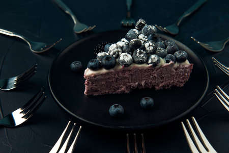 A piece of cottage cheese casserole and dessert forks on the dark textured background.の写真素材