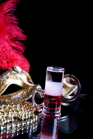 Multi-Layered cocktail and Venetian mask on a black background.の写真素材