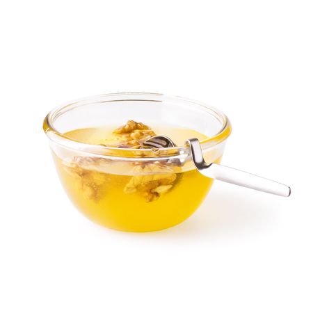 bee honey with walnuts on white backgroundの写真素材