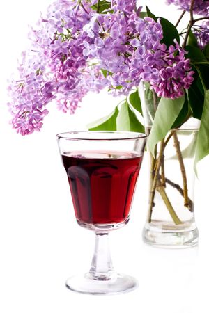 Syringa and glass of red wine on white backgroundの写真素材