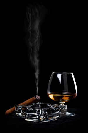 Snifter glass of cognac and cigarの写真素材