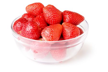 A glass bowl full of fresh strawberries.Isolated on white backgroundの写真素材