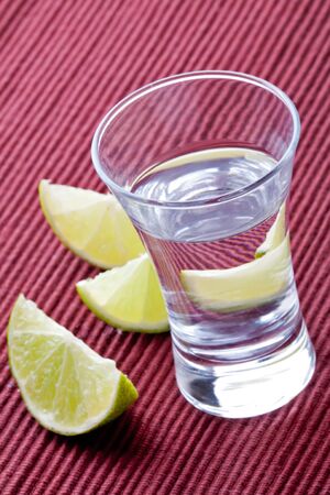 shot glass filled with clear cold alcoholの写真素材