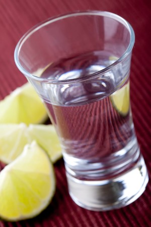 shot glass filled with clear cold alcoholの写真素材