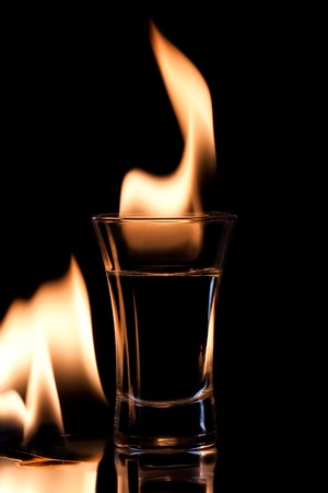 Flaming vodca, and lime over blackの写真素材