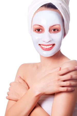 beautiful young woman with cosmetic mask on her faceの写真素材