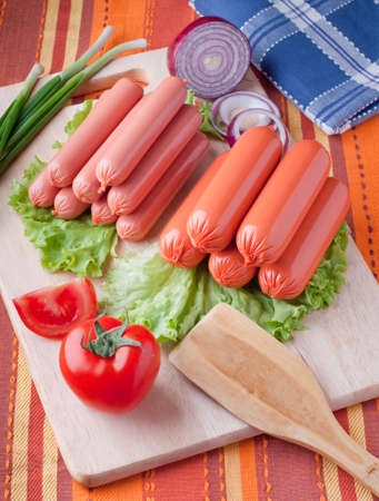 boiled sausage, on a wooden cutting board. の写真素材