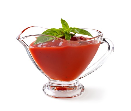 tomato sauce with basil leaf on a white backgroundand with soft shadowの写真素材