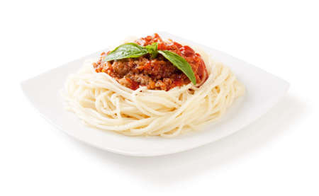 Spaghetti bolognese with cheese and basil on a white backgroundand with soft shadowの写真素材
