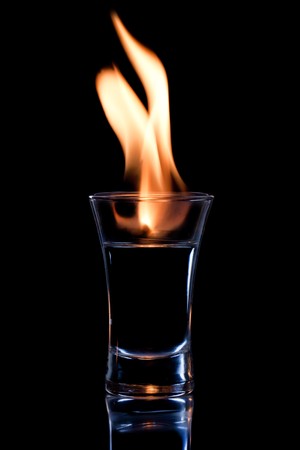 Flaming vodca, and lime over blackの写真素材