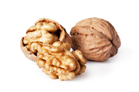 walnut and a cracked walnut isolated on the white background の写真素材