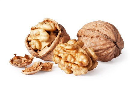 walnut and a cracked walnut isolated on the white background の写真素材