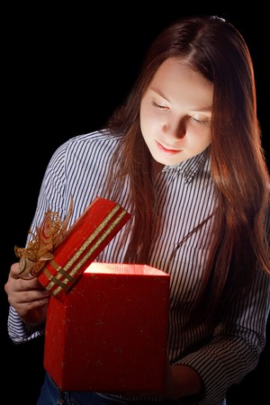 beautifull girl opening gift box. Black backgroundの写真素材