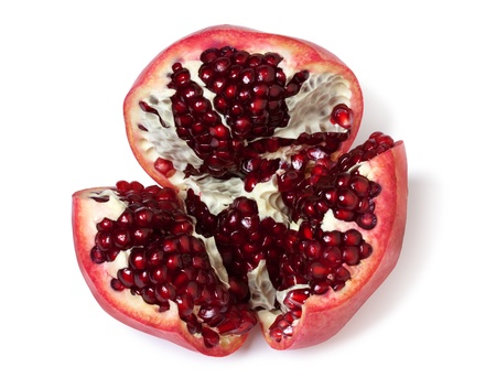 A piece of open pomegranate with seeds isolated on white backgroundの写真素材