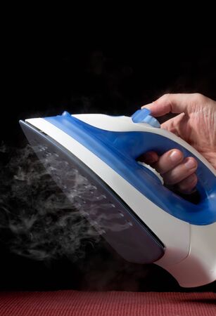 electric iron emitting steamの写真素材
