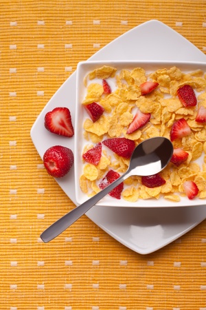cornflakes with milk and strawberriesの写真素材