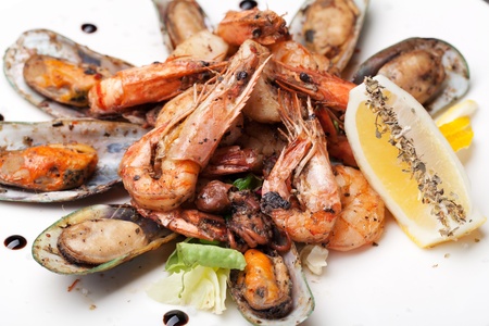 mussels and shrimp prepared on white plateの写真素材