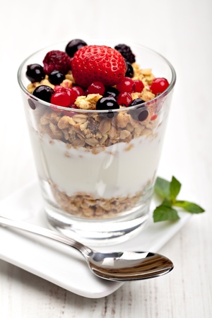 yogurt with muesli and berries in small glassの写真素材