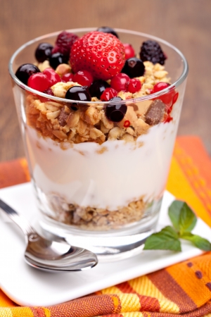 yogurt with muesli and berries in small glassの写真素材