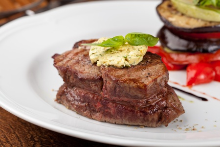 Closeup of a gourmet dinner plate with a steak, vegetables and potatoesの写真素材