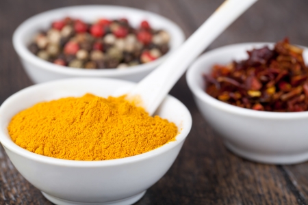 Spices Curry, Peppers Mix and paprika in in ceramic bowlの写真素材
